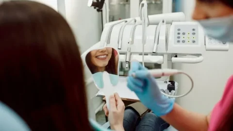 Dental Patient Smiling in Mirror