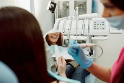 Dental patient smiling into mirror